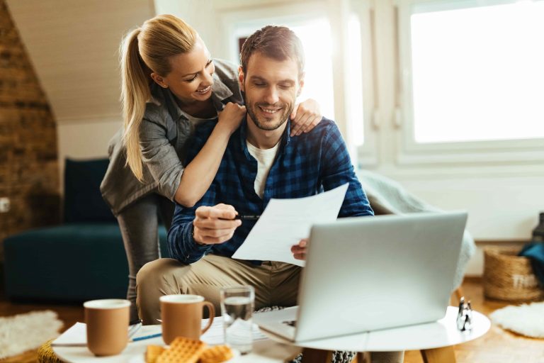 happy-couple-analyzing-their-home-budget-while-paying-bill-computer-scaled
